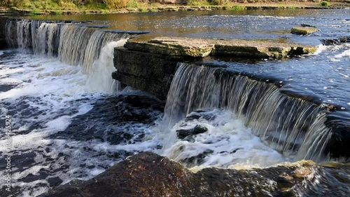 On the edge of the Tosnensky waterfall on an October day. Leningrad Region, Russia photo