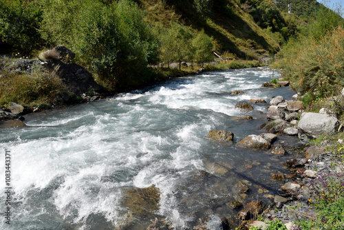 a stormy mountain river on a sunny day
