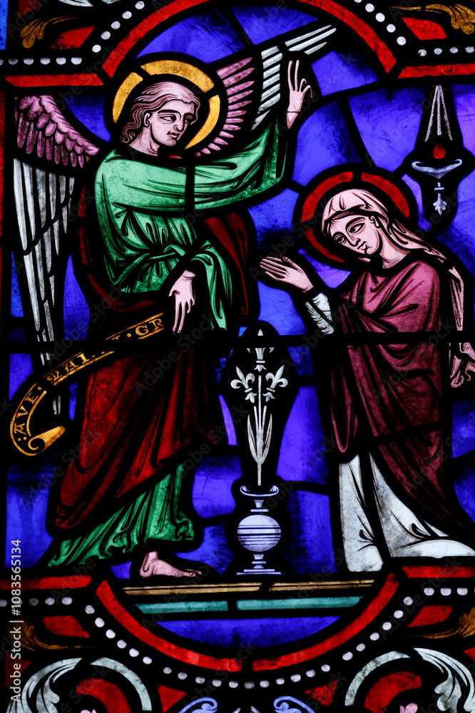 Obraz premium Saint Ferreol church. Stained glass window. The Annunciation by the angel Gabriel to the Virgin Mary. Saint Fargeau. France.