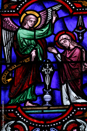 Saint Ferreol church.  Stained glass window.  The Annunciation by the angel Gabriel to the Virgin Mary. Saint Fargeau.  France. photo