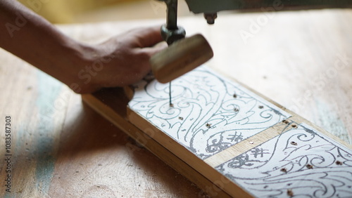 The initial process of making traditional Javanese Gebyok is made from whole wood which is cut and carved using simple tools by wood craftsmen. photo