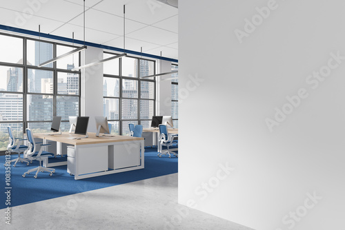 Modern office space with empty white wall and open workstation area in city background. 3D Rendering photo