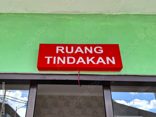 warning board with the words ruang tindakan in English action room. special room for emergency patients in a hospital photo