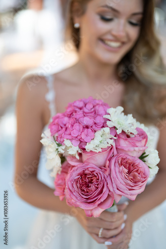 The bride holds her bouquet
 photo