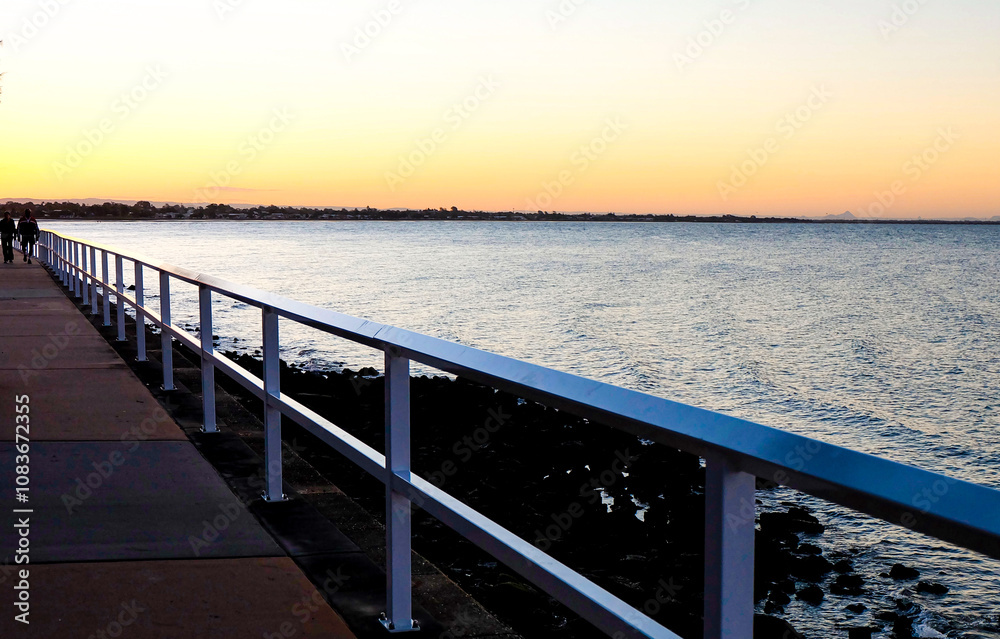 Obraz premium Sunset, purple and orange dawn sky at Shorncliffe pier, jetty, beach and bayside views, QLD