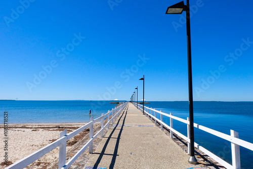 Walking along the seaside at Wynnum jetty and Manly, a beautiful sunny clear and blue sky day  photo