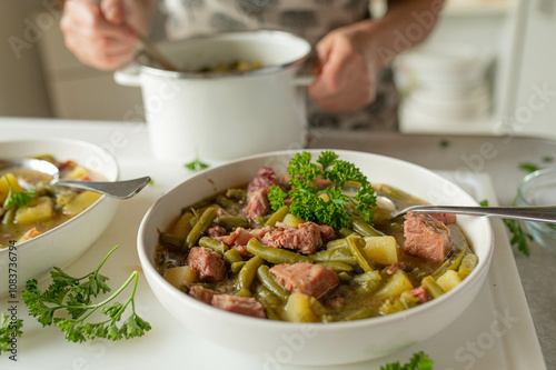 Wallpaper Mural Green bean soup with pork meat and potatoes fresh and homemade cooked. Served by a woman with apron in the kitchen Torontodigital.ca