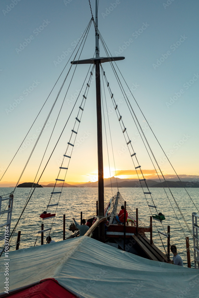Obraz premium View from a tourist catamaran boat on Ilha Grande (Big Island), sunset in Angra dos Reis Bay, beach vacation on the coast of Rio de Janeiro, Brazil