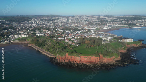 Torbay, Devon, England: DRONE VIEWS: The drone circles Roundham Head showing Paignton, Paignton Pier, Torbay, Torquay and Thatcher Rock. Torbay is a popular UK holiday destination (Clip 5).