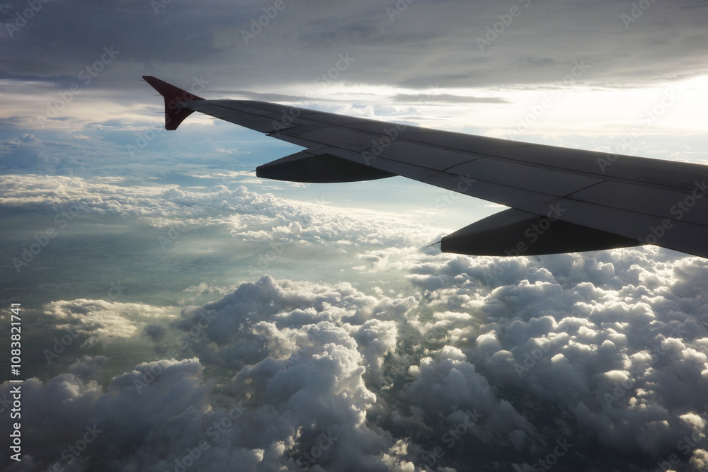 Obraz premium Airplane wing and clouds, taken on an airplane photo