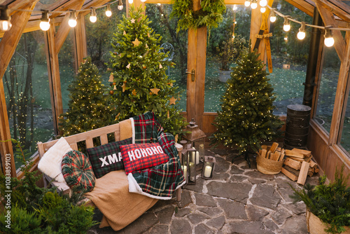 A cozy Christmas-decorated greenhouse or sunroom with festive trees, blankets, and glowing lights, creating a warm, holiday atmosphere.