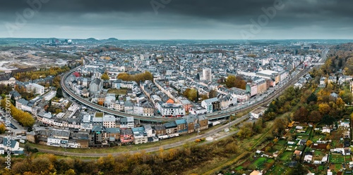 Aerial drone panoramic view of Esch-sur-Alzette, Luxembourg showcasing urban landscape and surrounding nature in fall