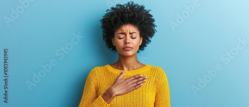 Woman taking deep breath with hand on chest, symptom of anxiety, mental health awareness, calming background