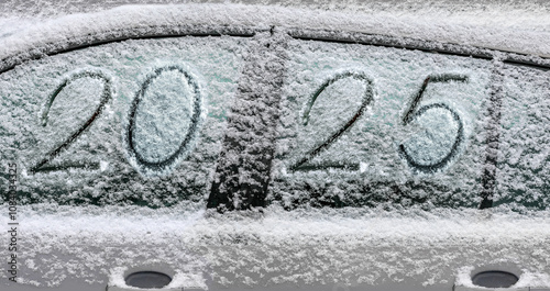 snow-covered car with the inscription 2025