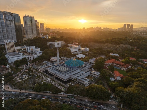 Photography Aerial drone view of the National Mosque of Malaysia at sunset in Kuala Lumpur,