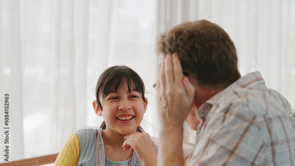 Fototapeta premium Grandfather and granddaughter together talking about entertainment media on TV. Old senior use conversation communicate with young generation cross generation gap strengthen family bond. Divergence.