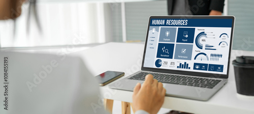 Human resources management software on computer screen helping human resources employee to manage recruitment, payroll, staff searching and KPI evaluation snugly