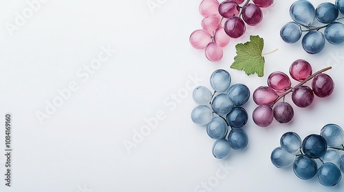   Grapes and broccoli sit on a white table