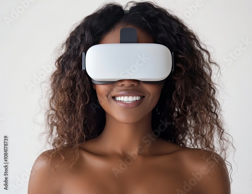 Young woman with curly hair experiences virtual reality technology in a brigh...