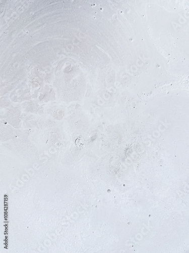 A close-up of a white plaster or concrete surface with small holes, ideal for minimalist, abstract backgrounds or industrial textures. Perfect for modern, neutral designs, and smooth, simple finishes.