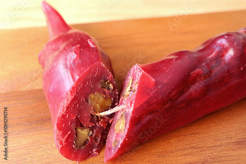 Closeup of Georgian Traditional Candy Stick Coating Chopped Nuts with Grape Juice Called Churchkhela	 photo