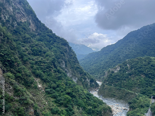 Serene Mountain Landscape With Lush Green Valley and Cloudy Sky
