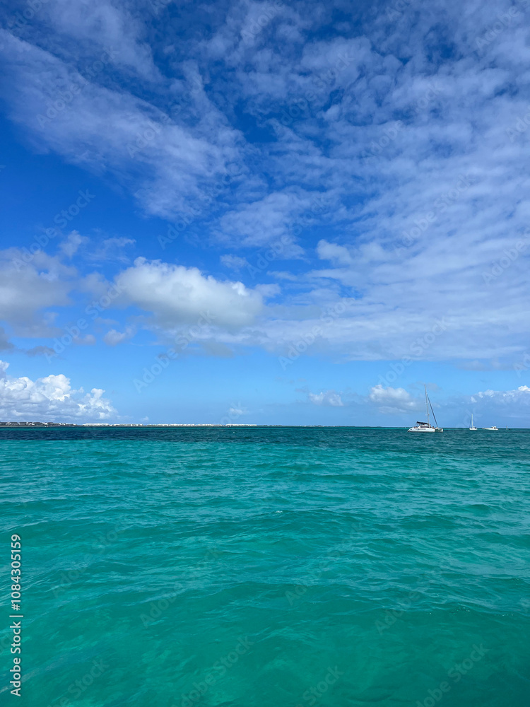 Fototapeta premium Serene Ocean View Under Clear Blue Sky with Sailboats