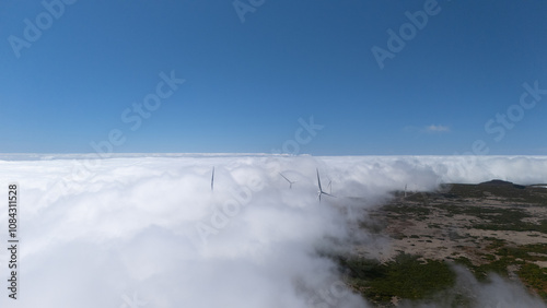 Wind Turbines Above Clouds in Scenic Landscape