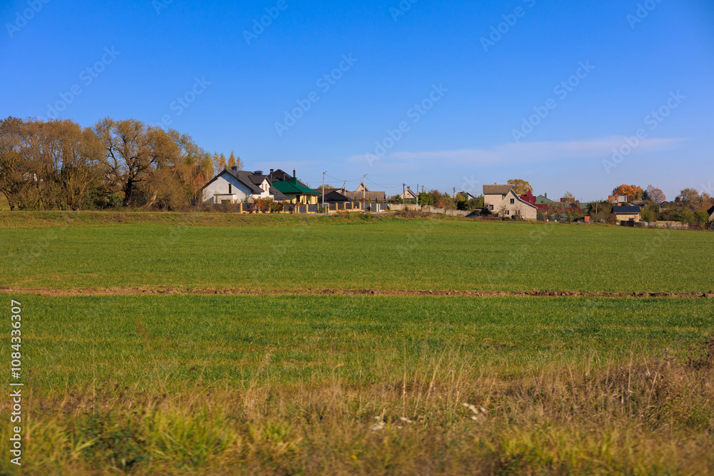 Fototapeta premium Road shoulder on a sunny autumn day. Views of the landscape from the car window.