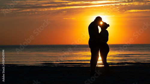 silhouette of a couple on a beach at sunset