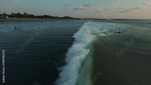 fpv drone view of surfing at sunset in bali