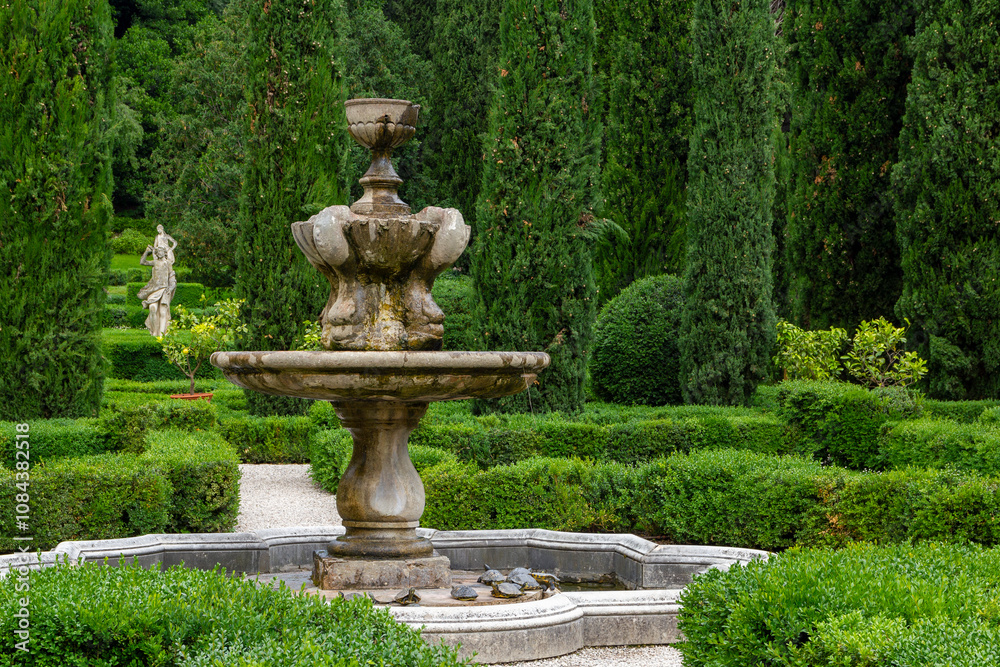 Obraz premium a stone fountain in the beautiful and unique city garden called Giardino Giusti in Verona, Italy. 