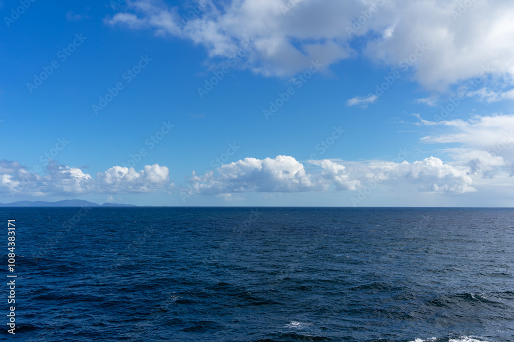 View of the Pacific Ocean and blue sky with clouds and horizon