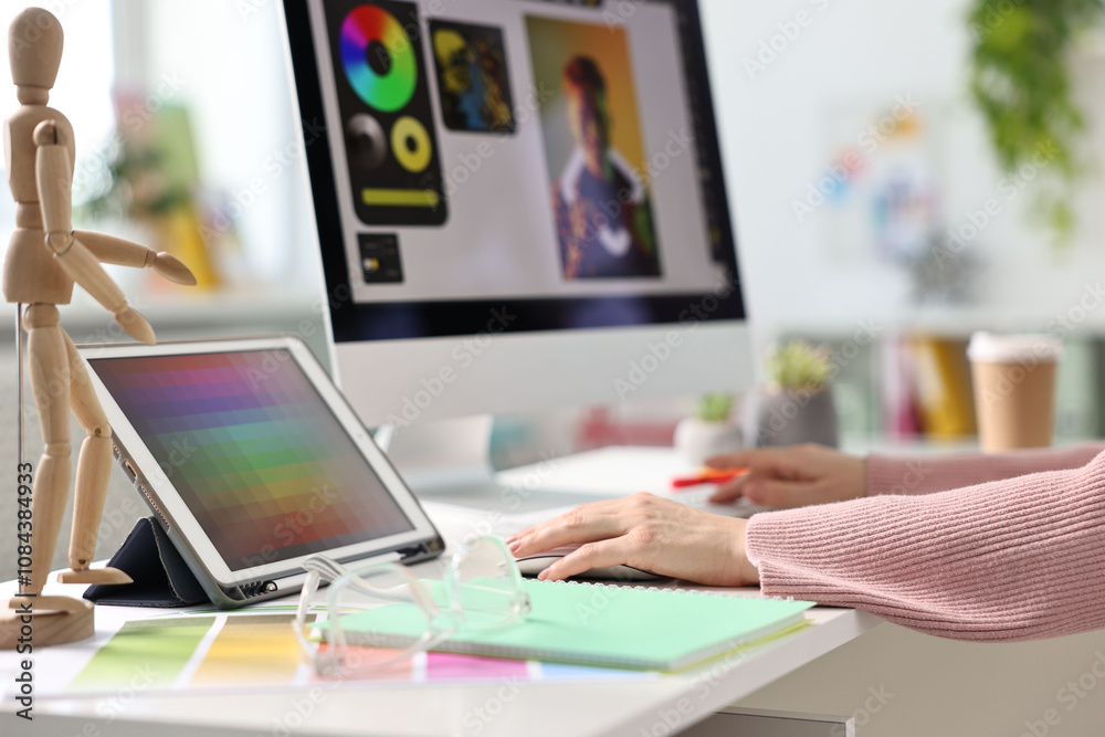Designer working at table in office, closeup Designer working at table in office, closeup