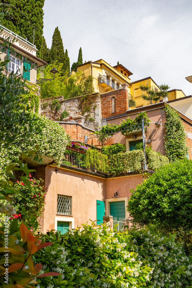 a beautiful vivid small alley with colorful tiny Italian villas on a steep hill in verona, Italy a beautiful vivid small alley with colorful tiny Italian villas on a steep hill in verona, Italy