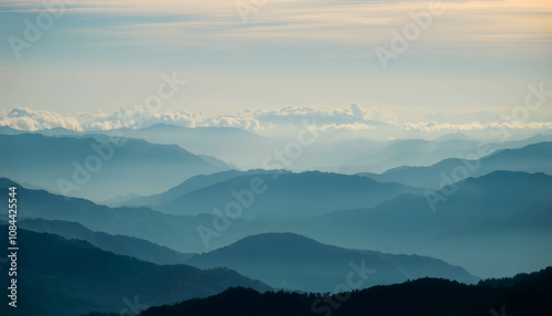 Layered Mountain Ranges: A majestic panorama of mountain ranges, bathed in the ethereal glow of a soft light, unfolds before your eyes. The layers of mountains.