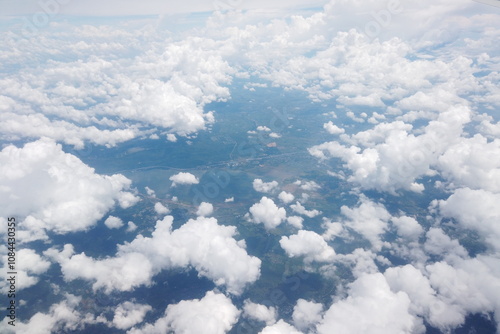 Aerial view of lush green landscapes and fluffy clouds above the earth nature photography serene atmosphere drone perspective nature's beauty