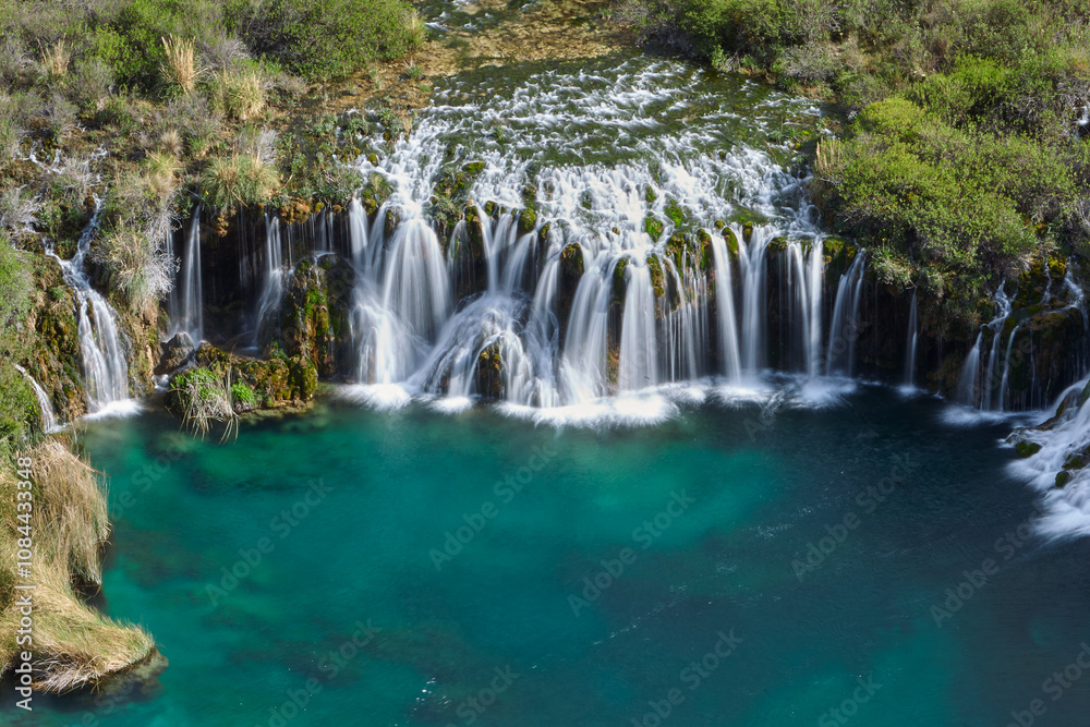 Fototapeta premium Nature’s symphony in full display. The breathtaking beauty of Huancaya Falls is like stepping into a dream. Nor Yauyos Lima Peru