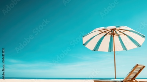 A serene, sunlit beach scene depicts a striped umbrella and comfortable chair beneath a clear, turquoise sky, inviting relaxation and tranquil bliss. photo