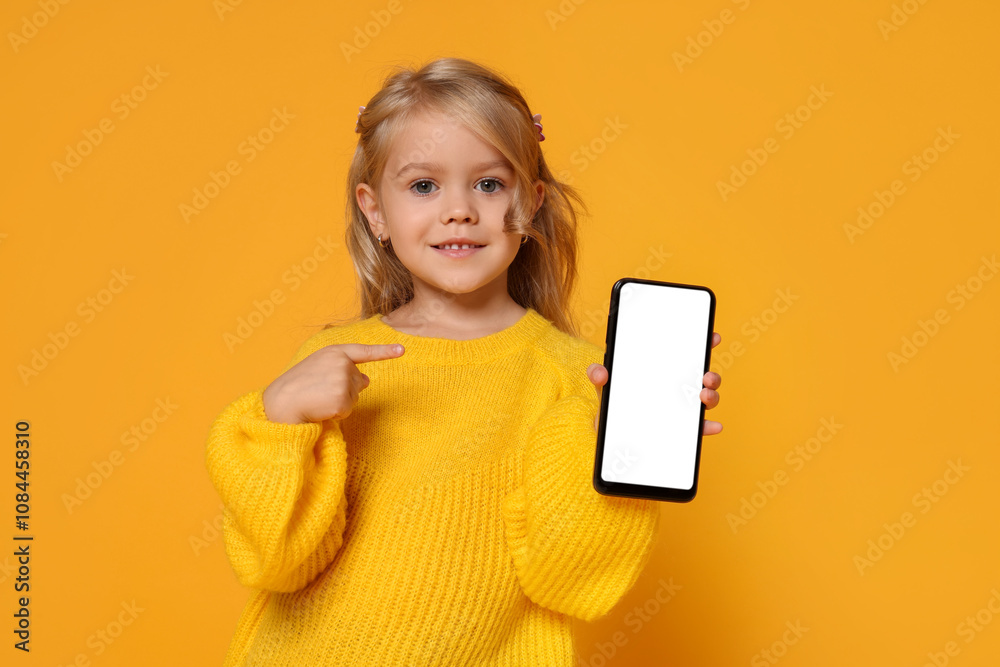 Cute little girl with smartphone against orange background Cute little girl with smartphone against orange background