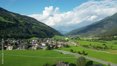 Aerial video of a valley in Austrian Alps, buildings and nature