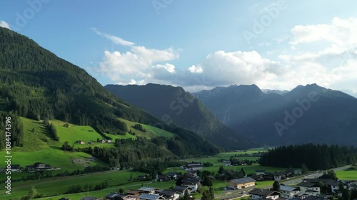 Aerial video of a valley in Austrian Alps, buildings and nature