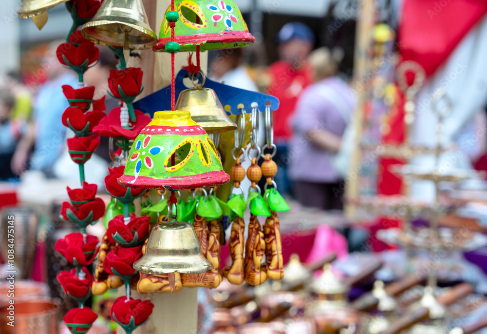 Сlay bell with Indian ornament on a street shop counter.