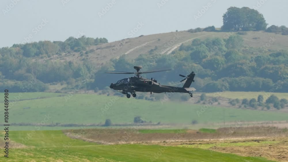 British army Boeing Apache Attack helicopter gunship AH64E AH-64E ArmyAirCorp AAC AH2 maintains a head-on, low-level hover in strong winds