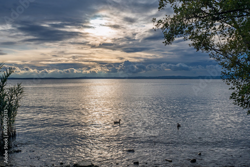 Abendstimmung mit wilden grauen Wolken am Gardasee In Lazise, Provinz Verona, Region Venetien, Italien photo