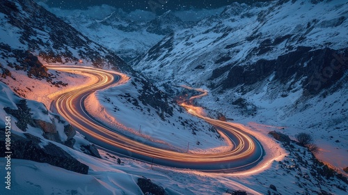 Winter dawn long exposure of winding dolomite road with car light trails. The winding mountain High Alpine Road Pass at night with light tracks from cars, Grossglockner high alpine road, Austria