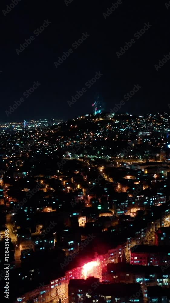 Vertical video of fireworks - aerial shot by drone of celebratory fireworks exploding over the city. Izmir, Turkey Vertical video of fireworks - aerial shot by drone of celebratory fireworks exploding over the city. Izmir, Turkey