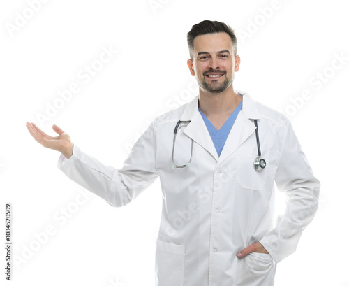 Smiling doctor with stethoscope pointing at something on white background