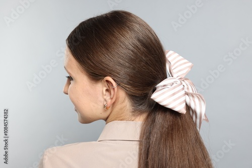 Wallpaper Mural Teenage girl with stylish hair band on light grey background, back view Torontodigital.ca