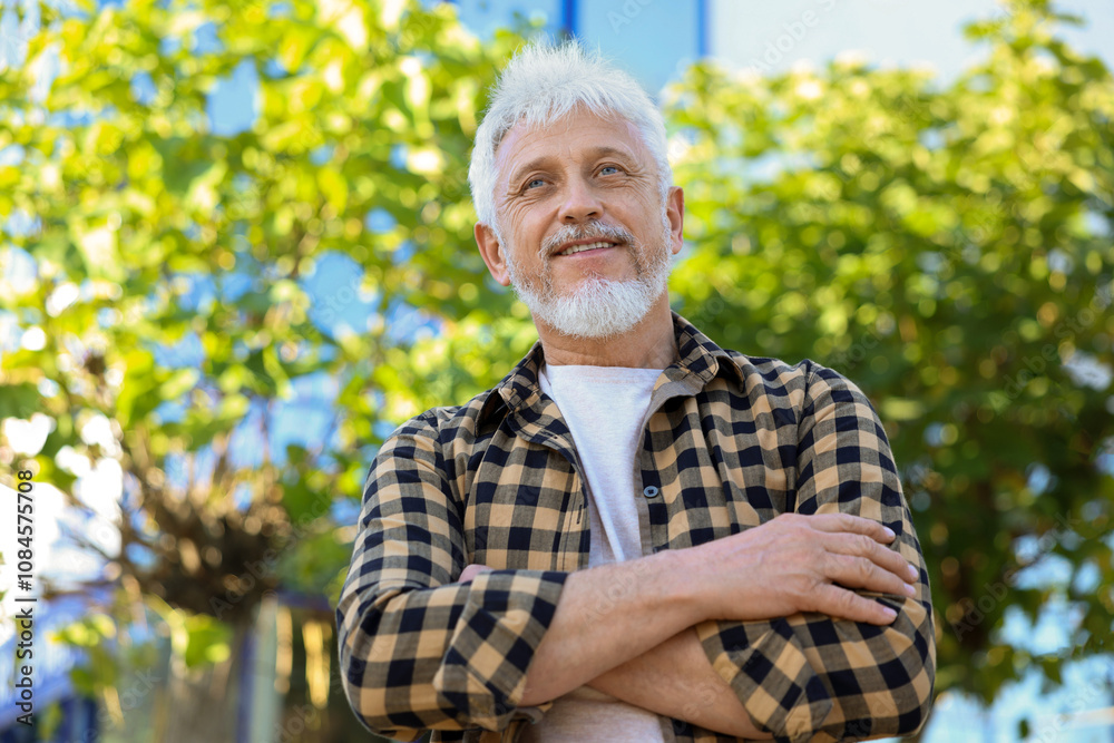 Smiling senior man outdoors, low angle view Smiling senior man outdoors, low angle view